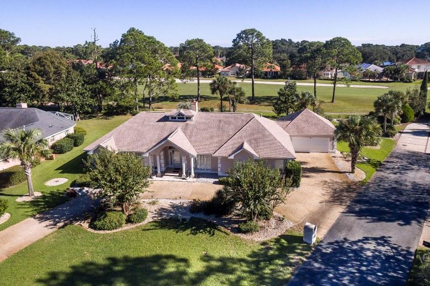 Golf course home in the gated community of Southwind in Bluewater Bay located on a quiet dead-end street. This custom built, one story, one owner home offers a split floorplan and multiple living areas. When you enter the home through the wide tiled foyer accented with graceful columns, you will find the dining room on the right and the office with convenient built ins on the left. In front of you is the living room featuring high ceilings and a lovely fireplace. The living room, dining room and office all have hard wood floors. Adjacent to the living room is the tiled Florida room offering wonderful views of the fairway. The kitchen has plenty of cabinet and counter space and the light and airy breakfast nook overlooks the golf course. The master suite also has convenient built ins