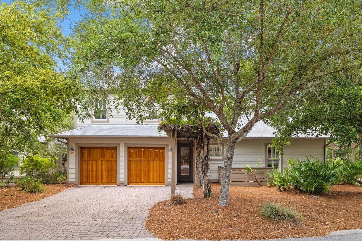 Situated on a quiet street in the premier enclave of Summer Ridge, this well-maintained single-family home is within walking distance to the beach and popular local restaurants. The home features a relaxing spa and a separate, well-appointed carriage house. Freshly painted inside and out, this custom home was constructed by the builder as his personal residence. It has been well maintained with new water tanks, landscaping, privacy louvers and updated interior lighting. The open family room and dining room are light and spacious beneath soaring ceilings. French doors allow seamless indoor-outdoor living with direct access to the covered porch, which has a reclaimed wood ceiling. The gourmet kitchen wows with a central island and Wolf and Sub-Zero appliances. Chefs will appreciate the six-burner gas cooktop and double oven with a warming drawer. Fresh white cabinets compliment with the granite countertops and rich wood flooring. The high-top breakfast bar is ideal for serving guests when entertaining. In addition, there's a separate bar area with wine cooler and ice maker. The master suite is on the main floor and pampers owners with his-and-hers custom closets, a jetted spa tub and a steam shower in the ensuite bathroom. The second floor has another well-appointed master suite. The home also features a stunning outdoor living space boasting a wet bar, built-in cabinets and a gas fireplace. Relax on deep cushioned armchairs overlooking the heated spa and water feature. Steps lead up to the spacious carriage house above the two-car garage with a bedroom/living area, bathroom, and kitchenette. There's a third climate-controlled garage for golf cart/storage. This home is replete with storage options between nine closets spread over 3,349 square feet of living space. Behind the privacy corner fence, the low-maintenance yard is irrigated with well water keeping the landscaping lush and green. Two pergolas offer respite from the Florida sun in a spacious backyard that is sized with room for a small pool. Recent upgrades include interior and exterior paint (2020), split system air conditioning in the carriage house and a privacy fence. This popular rental-restricted neighborhood has low HOA fees, a serene communal pool and plenty of restaurants and shops nearby. A bike path leads directly to the nearby beach for swimming and sunset walks along the sand.