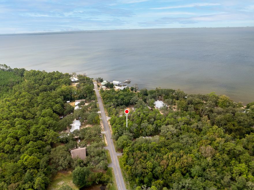 Your Coastal Lifestyle Awaits!Create your dream retreat on this rare .424-acre homesite, just 800 feet from the sparkling Choctawhatchee Bay, minutes from Basin Bayou, and only 6.6 miles to Choctaw Beach/ramp.  Nestled between Niceville and Freeport, this property offers the ideal blend of privacy and conveniences of shopping and coastal dining.Wake up to the sound of rustling hardwoods, spend your days boating, fishing, or kayaking, and wind down with breathtaking sunsets over the bay.This level, build-ready lot already has a PAID water tap in place, Electric available at the road and Flood Zone X designation giving you the freedom to design the home you've always envisioned.Mobile homes allowed!! No HOA, No Restrictions.Zoned Rural Village. Whether you picture a cozy cottage tucked beneath the trees or a spacious family retreat for entertainment.

Note: Bay View waterfront Pics are taken approximately 800 feet from Lot to the end of the Marsh Drive. These show it is a short stroll to take in the breathtaking views of the Choctawhatchee bay!!


***All dimensions shown in listings, platt and/or photos are approximate only. Buyer will be responsible to complete due diligence to ensure accuracy of all information.