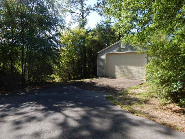 Beautiful one acre parcel only a few miles to downtown Crestview. This water front acre comes with a wonderful 24x48 shop. The shop is wind rated to 150 MPH and is about 5 years old but only slightly used for storage in the past. The land will ready to build on and offers seclusion. Located in the county for lowered property taxes, this property has so many options and could be a great investment. This water front property is part of a lot line adjustment that has been surveyed. The seller had the property surveyed and created 2 one acre parcels. M/L. The property being offered is the rear property and is Water front ! Both parcels can be bought for $82,500. Yhis has a wonderful shop already in place and waiting for your new custom home. The new survey is available now !