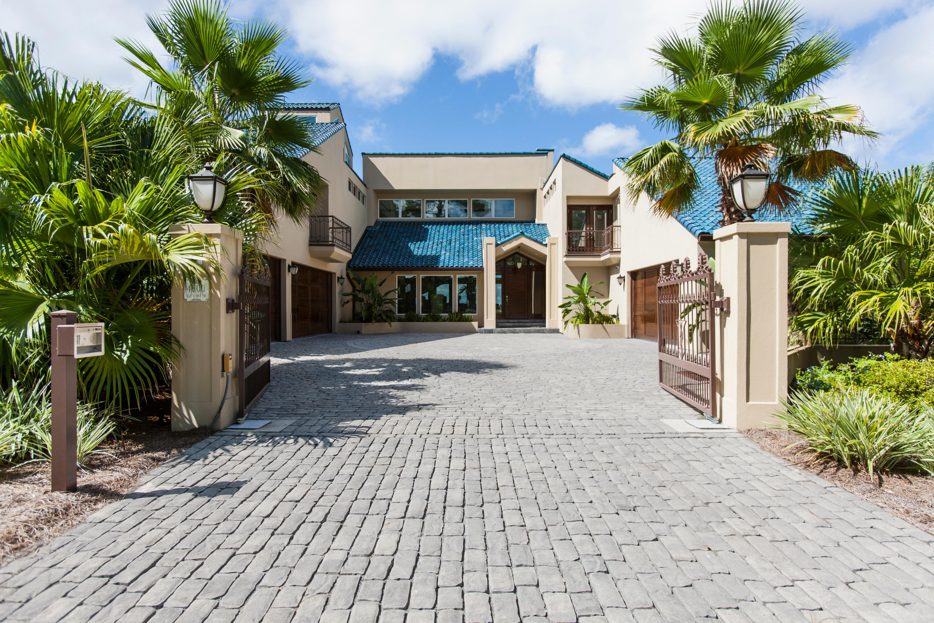 Incredible custom home situated on a large bay front lot in the desirable gated Bay Point Golf and Yacht Club community. This must see home was completely renovated in 2015 at a cost of over $2,000,000 and features exceptional construction, quality materials, with a private gated entrance all on 90 feet of bay frontage and just minutes away from the pass. The formal dining area is adjacent to the living area and the updated gourmet Chef's Exhibition kitchen that will please even the most demanding of cooks that features Sub Zero and Wolf commercial grade appliances throughout, a large center island for entertaining, gleaming marble counter tops and fabulous butler's pantry next to the kitchen has lots of storage and counter space for easy entertaining. Also on this level is the incredible