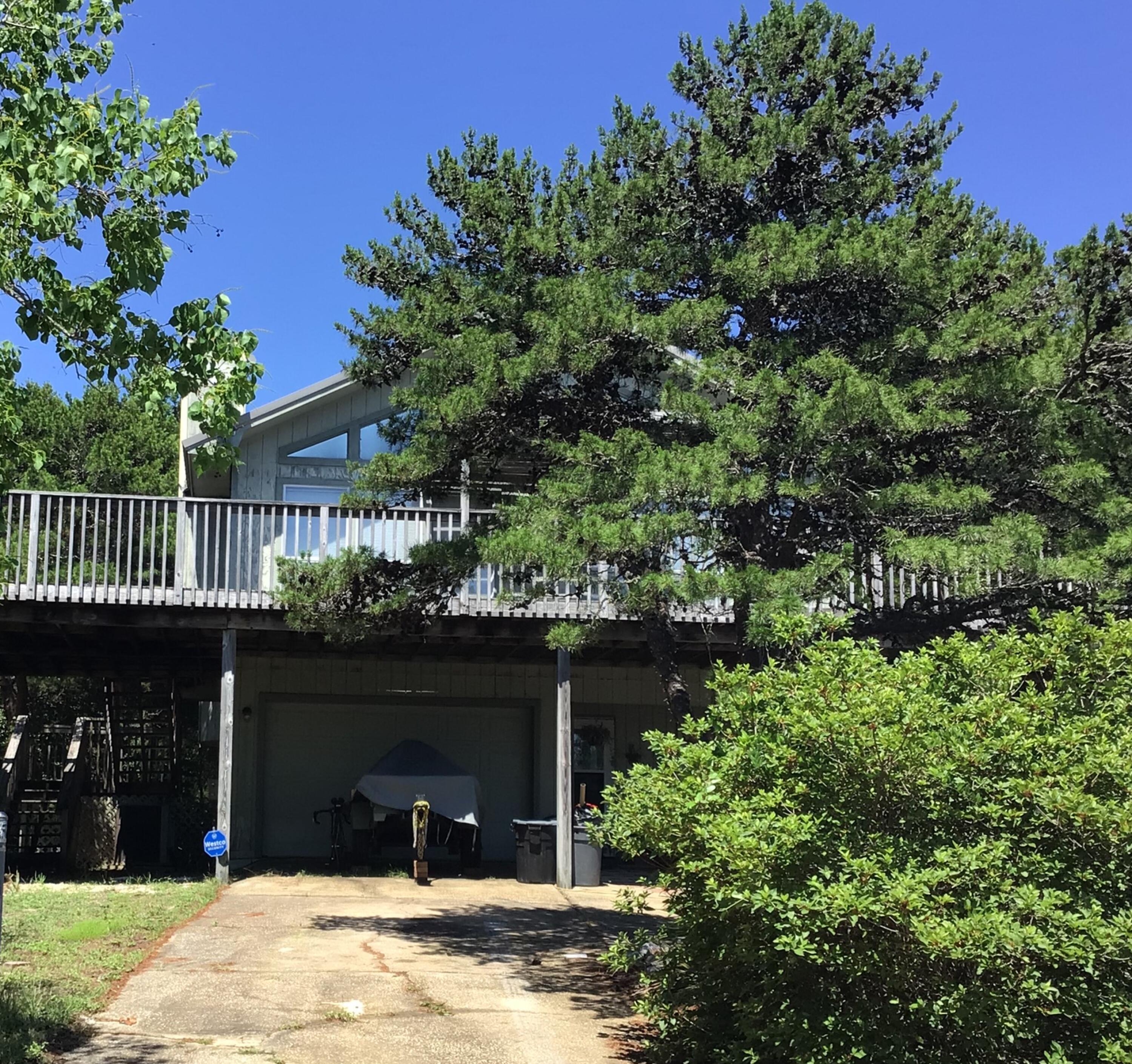 Why build new whn you can renovate! Large, wooded, .5 acre homesite very high elevation on newly paved street coveted in Blue Mt. Beach! Flood Zone 'X' - to be verified by buyer. Approx. 1/2 mile to County owned beach/County Park with golf cart parking. Eclectic, Old Florida style subdivision with NO HOA! Expansive lot provides room for main and carriage houses, courtyard, pool and plenty of parking. Short term rentals allowed. There is currently a 1,960 sq', 3 BR 2 BA Florida cottage in need of complete renovation or tear down and start new . Property including lot may ONLY be viewed with appointment-list agent must accompany. Being sold 'AS-IS.' Seller does not have a survey.