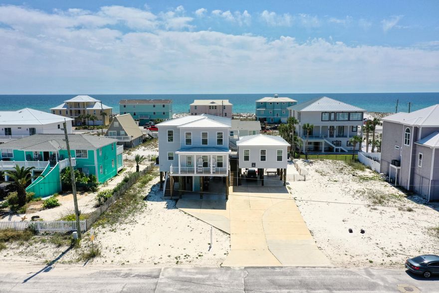 TWO HOMES FOR THE PRICE OF ONE!!! If you are looking for your dream property, look no further!!! This BEAUTIFUL home offers so much to all BEACH LOVERS or the business investor in you.  Live in the main home while you earn an income on your cottage.  Or put both on a rental program and book your favorite getaways throughout the year!!  Whichever you decide you won't be disappointed, and just being under 2 years old everything is turn-key and ready for you! This beautiful home is just short walk to the white sandy beaches and comes fully furnished with breathtaking views of the Gulf and Sound.  The spacious kitchen is opened up to the family room to allow for great bonding time.