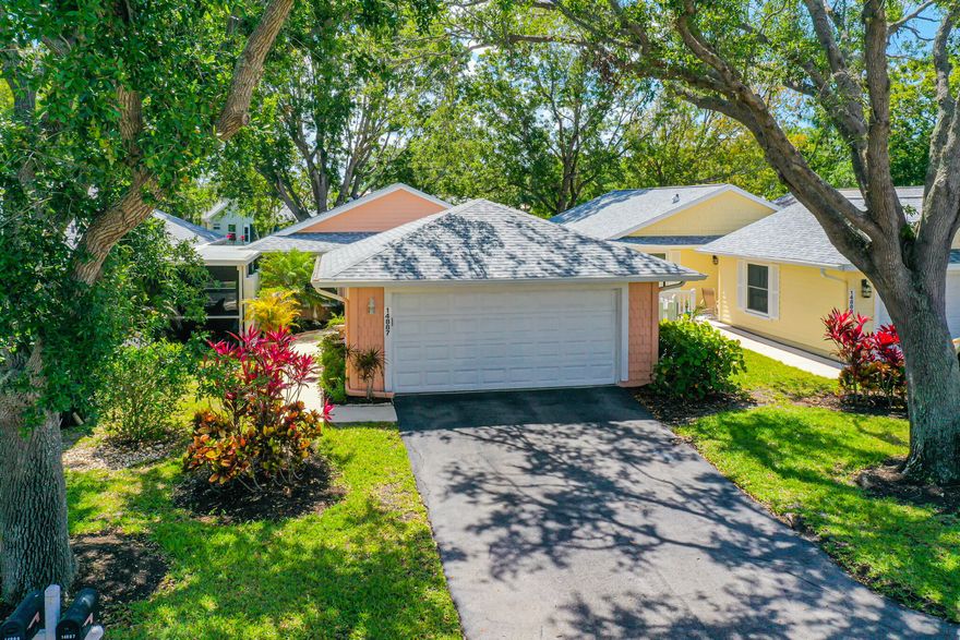 Welcome to your dream home located in Gulf Harbour Yacht & Country Club within the charming village of Crooked Pond. This beautiful two-bed, two-bath home is situated on a quiet street with mature trees and is just a few steps away from the community pool. As you enter this gorgeous home, you will immediately notice the chef's kitchen that features top-of-the-line Bosch stainless steel appliances, granite countertops, and a custom glass backsplash. The exceptional Omega pumice cherry cabinets include soft-close drawers, appliance garages, and split-turning spice racks, making this kitchen a true chef's delight. The open floor plan with vaulted ceilings is perfect for today's living and includes a beautiful Florida room and open patio for relaxing and soaking up the sun.  The