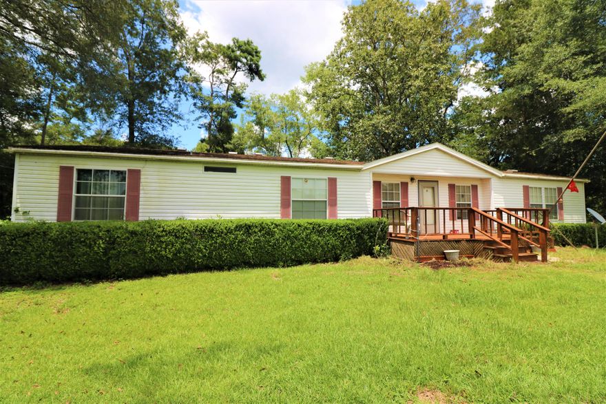 Do you want a whopping 660 feet of waterfront on Wright's Creek? If so, then this 20 acres of lush green land and home is your answer. You will love the tranquil country atmosphere and will be subject to frequent sightings of deer, hawks, owls, otters, cranes, and many other birds. Bring your fishing poles and get ready to catch bass, bream, stumpknockers, and catfish. New: Well and pump, HVAC 2019, Roof approx. 2014, water heater 2010, stove 2010, and dishwasher approx. 2014. Enter the home to the spacious living room featuring a wood burning fireplace and views to the water. The kitchen boasts an island with attached eat-in bar, appliances that convey, and lots of cabinets. To top this, when you wash dishes you will be looking out at your beautiful deck, nature, and your creek frontage. a dining area adjoining the kitchen with sliding glass doors to your gorgeous back deck. The laundry room and pantry are on other side of the kitchen with a door to the back deck as well. Fall in love with your primary bedroom because it has a massive walk through closet, corner tub with mirrors, separate shower, floor to ceiling 3 level storage cabinets, and a double vanity. Property also has a 24x12 ft. workshop with electric and a 58x16 ft. steel arched drive through carport. Here's your bonus greenery: Crepe myrtles, soft pink confederate rose bush, banana trees, garlic plants, lemon tree, blueberry bushes, and scuppernongs. There is a fenced garden area that just needs a little weeding. You will even have a free little boat thrown into the deal! Holmes county is supposedly paving all dirt roads with grant money. The current road is paved almost up to this property and very well maintained and graded.