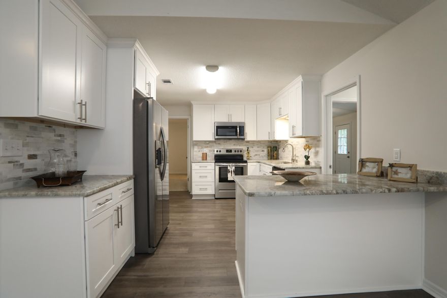 Professionally remodeled home in heart of Crestview.. 3 broken windows on order..75k In rehab costs!!  3/2 or 4/2  Ranch house with spacious front porch. New roof, New Ac, New kitchen with granite and stainless steel appliances and updated baths ,New fans and lights, open floor plan between kitchen and living room. Laundry room off of Kitchen. Bonus room or 4th bedroom Nice carport. Large Master bedroom with huge master bath. Laminate floors throughout. Hot Water heater is newer but not new .. Was in place prior to rehab..