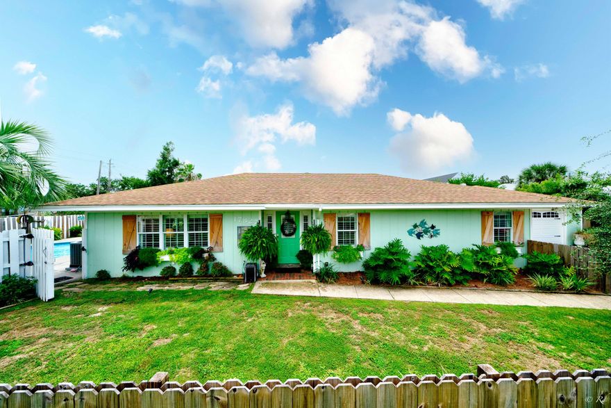 Stunning 3 bed, 2 bath home with a detached MIL suite and saltwater pool located on a corner lot just blocks from the beach. This property will wow you from the moment you arrive! The front yard is landscaped and adorned with a double-sided privacy fence, palm trees and pampas grass bushes. The windows are equipped with planters and plantation shutters along with plantation blinds throughout the home. Wood-look tile throughout the home provides the durability of tile with the modern look of LVP. This home welcomes with an inviting foyer. The open living room, dining area and kitchen boasts beautiful bullnose arches. The open floor plan offers a grand spot to host family and friends without missing a beat. The kitchen features stainless appliances including a double door refrigerator