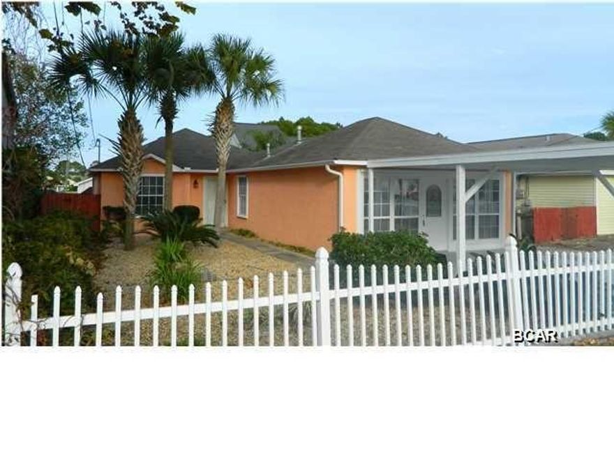 Beautiful beach home conveniently located near the Navy Base located off south side of Thomas Drive and less than 1/2 mile to the beach. This 3BR/2BA was renovated by the owner. New roof installed in 2017. Updates include beautiful, marbled ceramic tile flooring throughout, kitchen countertops, and oil-rubbed bronze fixtures/fans. The open floor plan is perfect for entertaining with the kitchen overlooking the living room. It offers a gas fireplace with vaulted ceiling and sliding door access to the patio. Separate dining area located just off the kitchen. A huge bonus to this home is a large Florida room or den with access door to the covered carport. Come find out why the homes in Holiday Beach are desirable and the most sought-after homes in Panama City Beach!