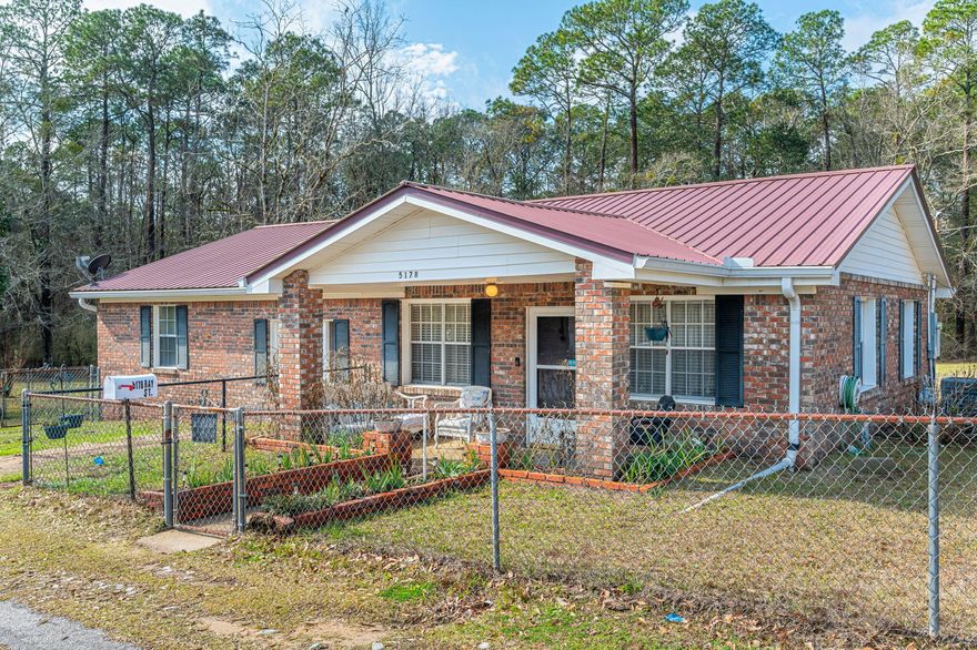 If the walls could talk... This 2 bedroom 1 bath home on 1.27 acres with a creek in the back is on the search for its new family. The spacious living room provides plenty of room for gathering the family for a family movie or game night. Huge covered back porch with custom bbq pit ready to entertain at family gatherings. Two storage buildings including a old well ( currently not functional but could be hooked up and primed). Move into this home and build your dream home behind it. Location provides easy commute to the local bases, beaches, and shopping centers. Home is pre-wired for use of generator if needed during power outage. Schedule your showing today.