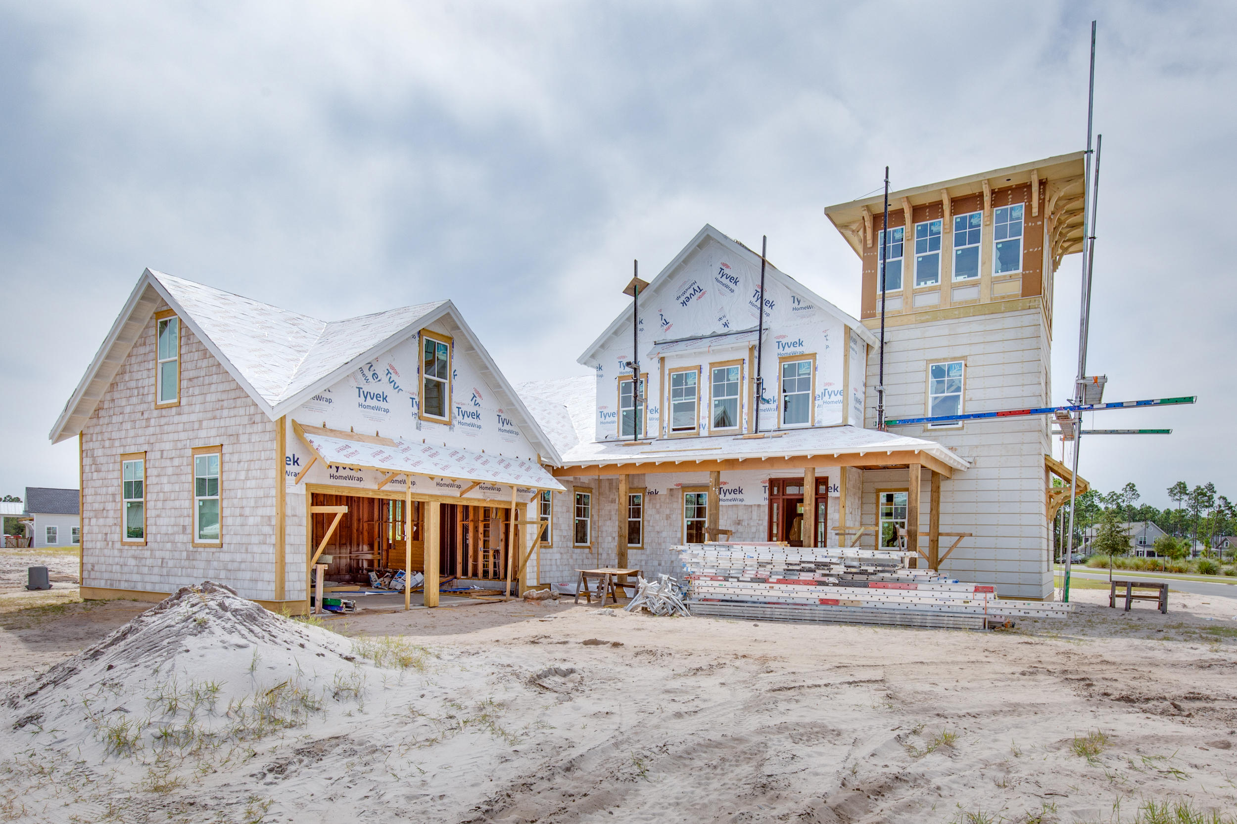 The Watchtower Plan, New from Dune Construction, sits on a large corner lot at the entrance to the Stillwater neighborhood. This 3,843 SF home showcases a unique third floor viewing tower and features many high end finishes including a  fully-equipped kitchen, great room, and dining room with 11' ceilings, wood beams, gas fireplace, and rounded wall of windows allowing for maximum natural light. The first floor master suite includes a spacious ensuite bathroom with walk-in shower, freestanding tub, massive closet, and direct access to the laundry room. Outdoor living is made simple and relaxing with a private pool, cabana with fireplace, and plenty of covered porches. The second floor includes 3 more bedrooms with a shared den for family entertainment.