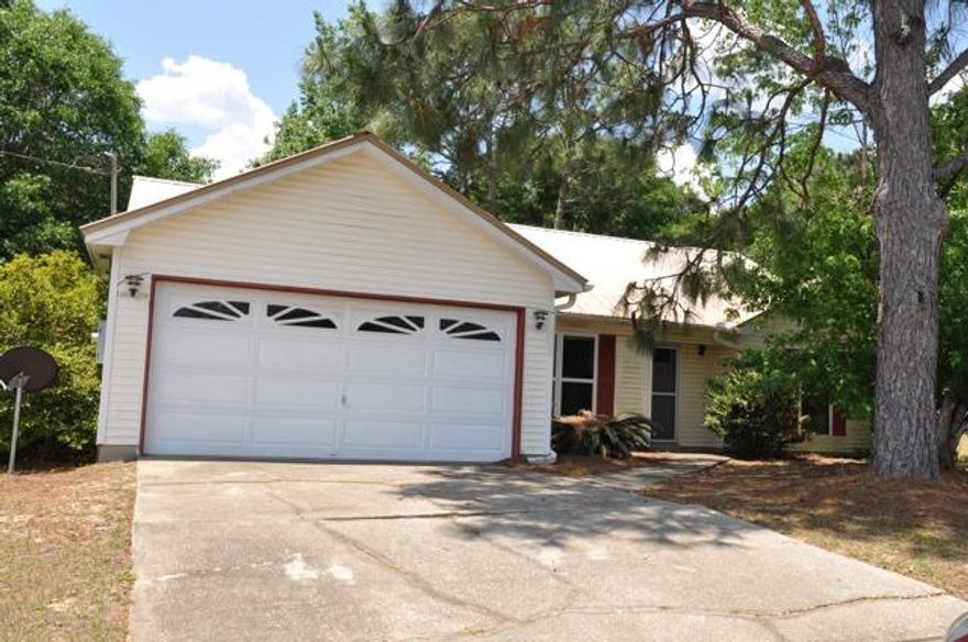 REO. Great home in south Crestview! Home features a great split bedroom floorplan, formal dining room, and a welcoming fireplace in the living room. The kitchen includes an island for spacious meal preparation and a pantry to store all of your kitchen essentials in. Because the home backs up to the woods, you will have a lot of peace and quiet in the backyard. Home features a Florida room where you can entertain guests and relax in after a long day. The backyard also comes with a workshop where you can store tools, work on projects, and so on. Because this home is conveniently located south of I-10, you have a quick commute to Duke Field and Eglin AFB. Being sold AS IS.