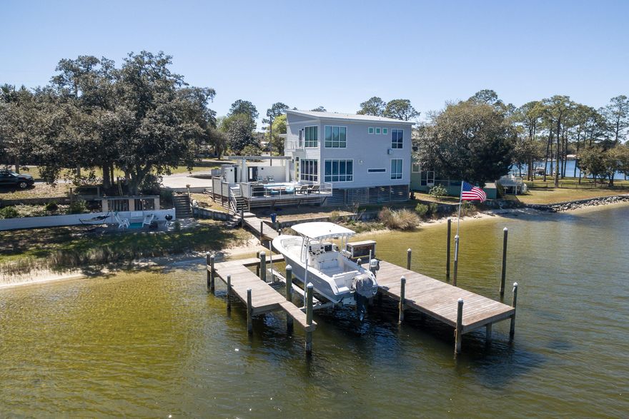 STUNNING custom-built waterfront home on 162' of the picturesque shore where Boggy Bayou and Toms Bayou meet in Valparaiso! This 2014 built home captures the magnificent sunrise and incredible moonrise over the bayou that will simply take your breath away. This home was designed to make you feel like you are on vacation at a luxury waterfront retreat offering amazing water views from EVERY room. In addition to living the carefree waterfront life you have been dreaming of, you will also enjoy watching boats cruise by as well as watching the annual 4th of July Niceville/Valparaiso fireworks show right from your own home. Whether you are an avid boater, fisherman or just want to enjoy the best waterfront lifestyle imaginable, you will find what you are looking for in this one-of-a-kind home.