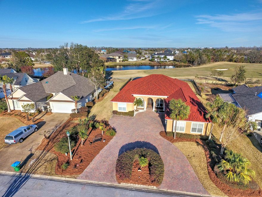 Just like new! Custom home on the Nicklaus Golf Course in the gated community of Bay Point! 3 car garage, paver driveway, screened in pool area, fenced in back yard, 4 bedrooms plus office, 3 and a half baths and single story living! This gorgeous home was built in 2005 and has a brand new roof with 50 year warranty. Enjoy an open floor plan with split bedrooms, wood and tile flooring throughout, 13 ft ceilings, custom cabinets, granite in kitchen and all bathrooms, crown molding, upgraded light fixtures, large windows for plenty of natural lighting, and more. This lovely home is beautiful inside and out. The back of this home is like a resort; with spacious covered patio for dining and relaxing, screened in pool, fireplace, large backyard, and amazing sunrise views. Views of the pond and