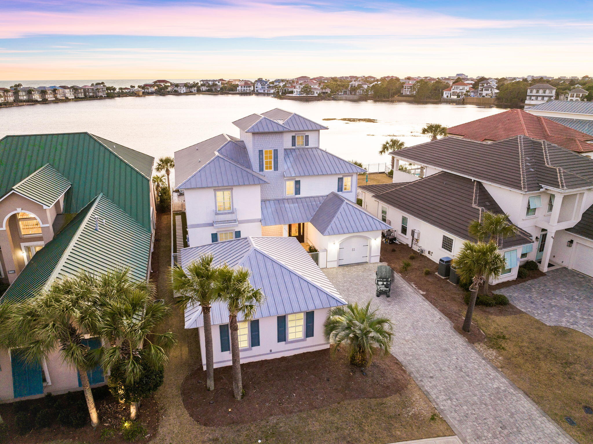 INVESTORS ALERT! This stunning property generated over $260,000 in gross rental income in 2023, making it a prime investment opportunity. Located on one of the most sought-after lots in Destiny East, this home offers unparalleled panoramic views of both the lake and the Gulf, arguably the best in Destin! Whether you're in the market for a primary residence, vacation getaway, or a high-performing rental property, 'Sundancer' has it all.Step inside to find charm and elegance at every turn, with custom finishes throughout. The open-concept kitchen flows seamlessly into expansive living areas, perfect for entertaining. With six spacious bedrooms, including a dedicated bunk room, there's plenty of space for family and guests to relax in comfort.