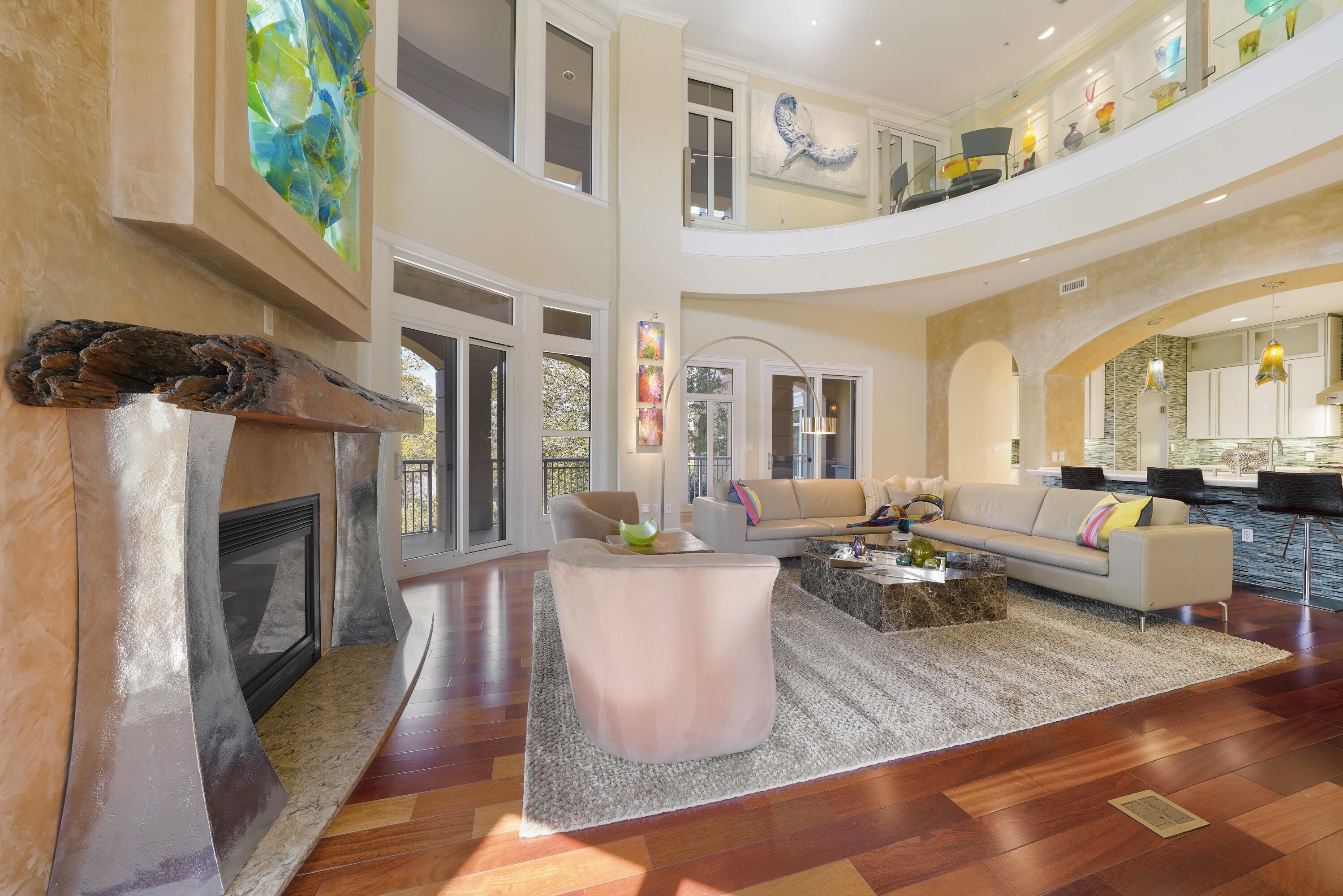 Welcome to Resort living that feels like a private home....minus all of the maintenance! This is a special opportunity to own one of only two Townhomes built in the coveted towers of One Water Place in Kelly Plantation. Walking into this two-story unit, you will forget that you are in a condominium. Find yourself surrounded by the privacy and beauty of treed wetlands, wildlife, gardens and fountains. The two-story open atrium is filled with windows immersing you in this lush beauty with no other buildings in sight. Assigned parking spaces are steps from the unit's front door, which means it is never necessary to use the building elevator. This two-story unit has its own internal private elevator as well as two deeded storage units and one of a very limited number of golf cart spaces. One Water Place is located within the guard-gated community of Kelly Plantation with beaches and shopping within walking distance or a quick golf cart ride. The interior of this home is defined by high end details! Decorated in collaboration with Duce and Company, you will be drawn to these beautiful touches such as textured wall coverings, venetian plaster, unique light fixtures, glass and stainless-steel railings. An impressive backlit sculpture created by local artist Brendan Parker makes an impressive statement over the Fireplace mantel. This extraordinary mantel is a natural piece of sinker cypress with sculptural polished stainless steel supports. The renovated kitchen boasts high-end appliances, stunning white Quartzite countertops, sleek European white and glass cabinets and is all accented by floor to ceiling colored glass tiles. Retreat to the elegant master suite and find yourself entering an entirely remodeled sanctuary where you can pamper yourself and relax. Storage space is everywhere! There is a place for everything with large walk-in closets in every bedroom all finished with premium drawers and shelving, a large walk-in pantry, several storage closets and areas of shelving and cabinetry throughout. Step out onto the wrap around balcony and enjoy the beauty. This outdoor space was completely updated including new tile flooring, gorgeous countertops, high-end grill and beverage refrigerator. One Water Place boasts a resort style list of amenities to enjoy that include a State-of-the-Art fitness center, Spa Treatment Rooms, a Heated Lap Pool, indoor and outdoor hot tubs, a Community Wine Room w/ Locker, Catering Kitchen, Party Lounge, Card Room, Dog Park, Workshop, Garden Room, Guest Suites, screened in Patio & Stone Fireplace, Walking Trails, Bocce Ball Court, Green Spaces with Reflection Ponds, Arbors, Covered Swings & Benches, recently redecorated building lobbies and more!