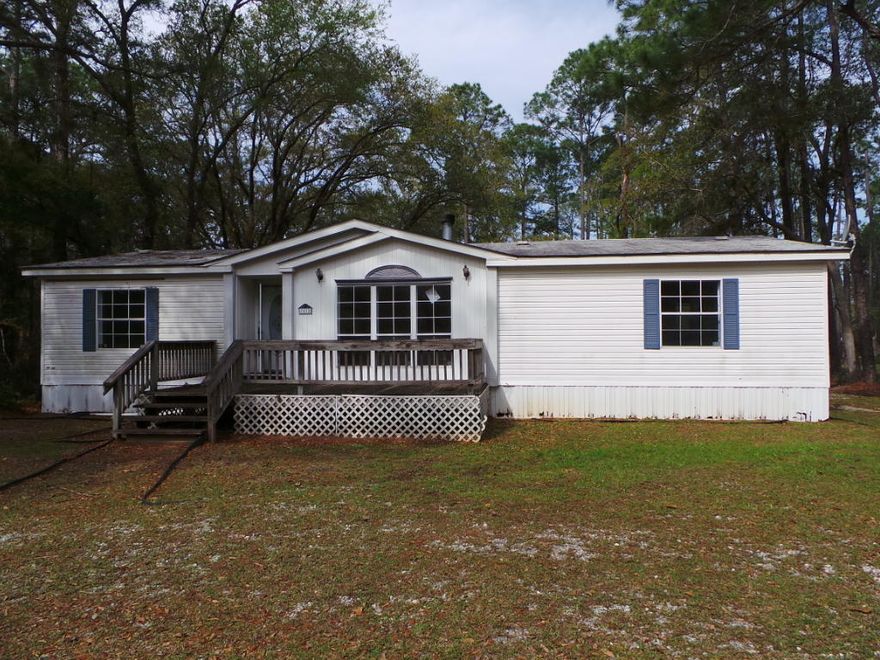 Three Bedroom Two Full Bathroom Mobile Home In Navarre! This ranch style mobile home has an open deck in the front and the back as well as a covered part of the back deck and a large workshop/storage. Its interior features vaulted ceilings, fireplace and inside laundry. Kitchen boasts tons of cabinets, counter tops, some appliances, island and adjacent dining area with built-in china hutch. Master Bedroom also offers vaulted ceilings and bath has a double vanity and center garden tub.
