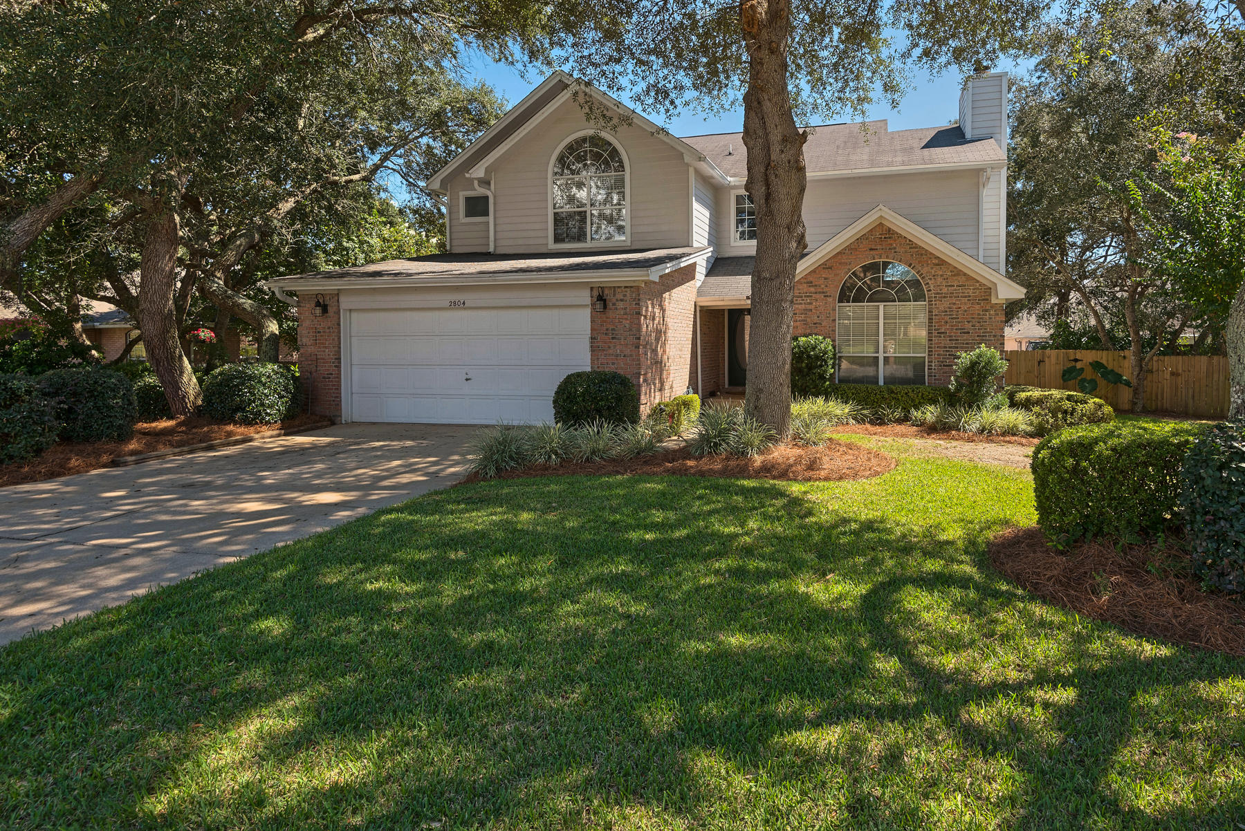 Turn-key, highly desirable 4 bedroom, 3 bath home with everything you want for living the ultimate Florida lifestyle. Located at the end of a cul-de-sac and within minutes to the beach, parks, shopping, and dining. The foyer has soaring 22' ceilings above the 13 x 26' formal living and dining area with a wood burning fireplace. In the kitchen, chefs will love the granite countertops, huge island/breakfast bar, and matching Whirlpool stainless steel appliances including refrigerator with water and ice through the door and a center drawer for easy access to snacks and drinks. There are plenty of cabinets and two pantries. Adjacent breakfast area flows into the informal family room, the ideal layout to spend time together as a family or to entertain guests. Take the party outside to the