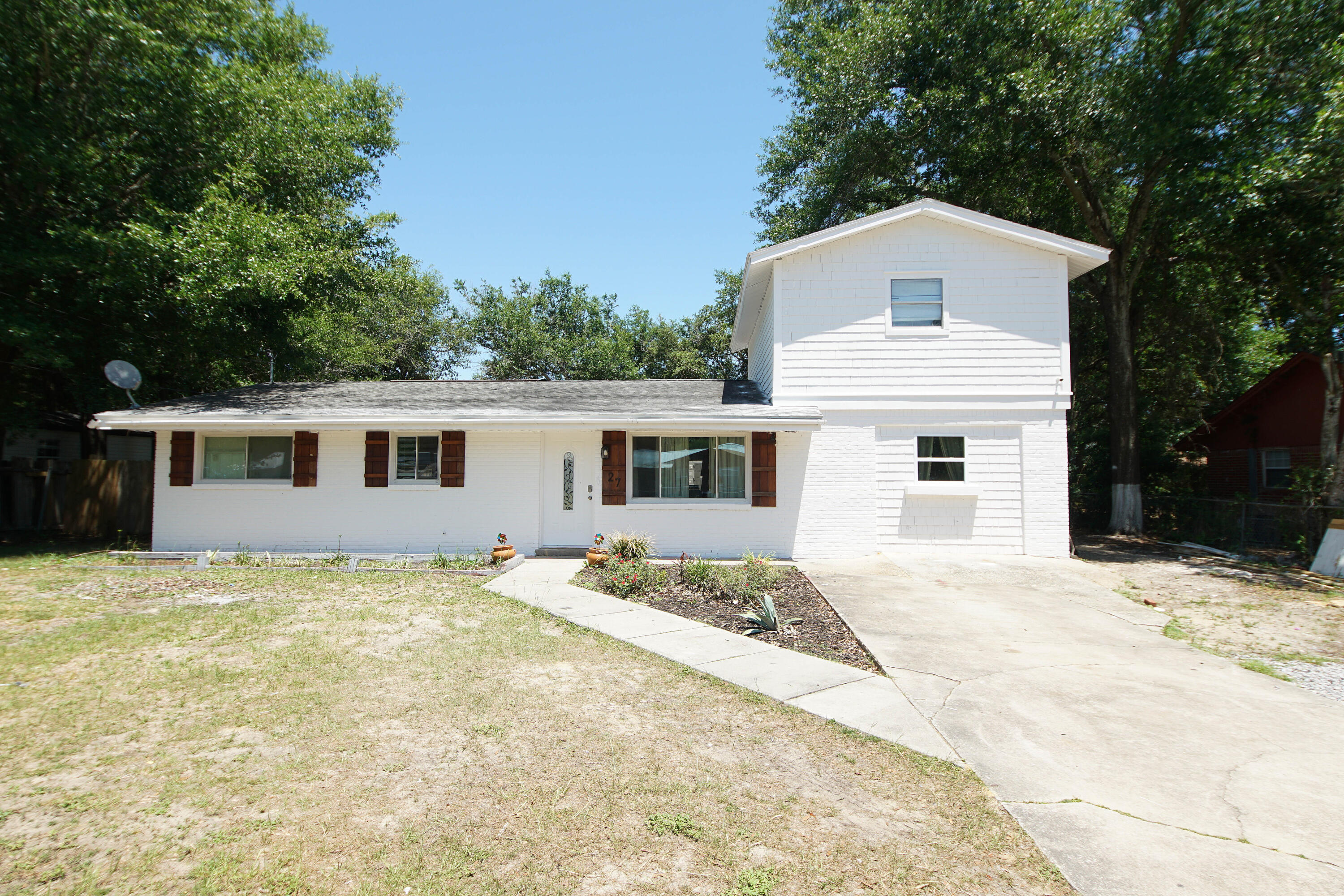 Welcome Home! Your new 4 bedroom 3 full bath home centrally located in Ft. Walton Beach has been updated through out with  many unique characteristics.  Brick walls, ship lap, custom tile , and an open floor plan create many special touches to this beautiful home.  The kitchen has been opened up between the living room and dining area to host friends and family. The white and black kitchen is stunning with tile back splash, ship lap walls and custom white cabinets.  The kitchen island features a waterfall of white quartz and a farmhouse sink finish off this gorgeous kitchen. Downstairs you have 3 bedrooms and 2 full baths. The master bedroom has an ensuite with double vanities and a large walk in shower. The bedroom also boast a custom walk in closet with built in shelvesi