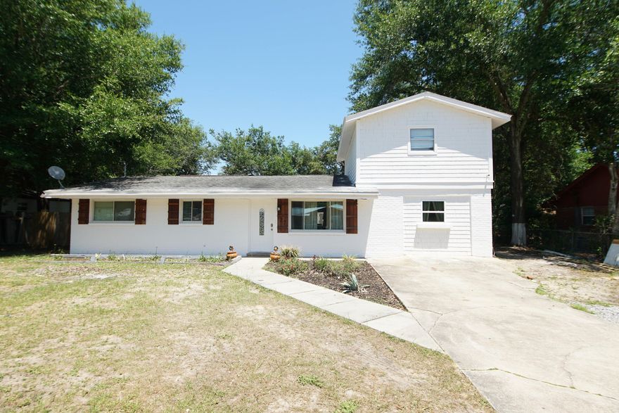 Welcome Home! Your new 4 bedroom 3 full bath home centrally located in Ft. Walton Beach has been updated through out with  many unique characteristics.  Brick walls, ship lap, custom tile , and an open floor plan create many special touches to this beautiful home.  The kitchen has been opened up between the living room and dining area to host friends and family. The white and black kitchen is stunning with tile back splash, ship lap walls and custom white cabinets.  The kitchen island features a waterfall of white quartz and a farmhouse sink finish off this gorgeous kitchen. Downstairs you have 3 bedrooms and 2 full baths. The master bedroom has an ensuite with double vanities and a large walk in shower. The bedroom also boast a custom walk in closet with built in shelvesi