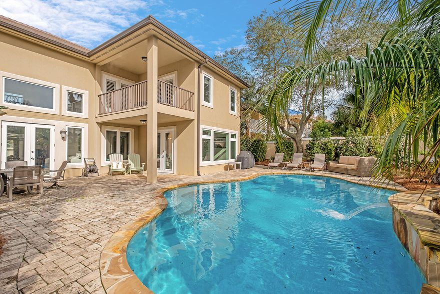 Ideally located in the upscale, gated community of Destiny East, just steps from the beach via sidewalk or golf cart, this beautifully remodeled home boasts countless stunning and thoughtful upgrades.  Included in these notable highlights are the new roof, new gutters, pool pump, updated water heaters, doors and windows.  This two-story home encompassing 2560 square feet with three bedrooms and three baths and an accommodating two-car garage with space for a golf cart, kayak and paddle boards, beach gear and toys.  Inside, modern designer finishes unfold as visitors step through the spectacular grand foyer framed with a sweeping custom staircase.  Natural light pours from the floor to ceiling windows setting the airy, spacious tone for the large, open concept living area and kitchen. The beautiful gourmet kitchen is well appointed with stainless steel appliances including a new refrigerator, gas cooktop, modern microwave-over-oven, and bar area with wine cooler.  Pristine white shaker cabinets paired with custom countertops provide an abundance of storage and counter space, including a large island with seating for six. Entertainment is made easy with a large dining area for enjoying meals and glass doors leading to the outside living space with the pool and waterfall. The spacious second level bedrooms and tasteful bathrooms provide a peaceful respite, while the private balcony gives a separate oasis to take in the salty breeze. Owners will indulge themselves in a backyard oasis created by the serene, landscaped backyard surrounding the Blue Haven heated pool, complete with a waterfall feature, tanning ledge and wonderful night lighting. 
Destiny East is an amenity-rich, golf-cart friendly community, close to all the Emerald Coast's activities, restaurants, and shopping.   This sister community of Destiny by the Sea and Destiny West, is located directly on Scenic Hwy 98 with direct access to both Scenic Hwy 98 and US Hwy 98, providing quick access to shopping, dining, and all Destin has to offer.  Public beach access with food and restrooms on-site is just a short walk away.  This luxury gated community boasts deluxe amenities including a huge lagoon-style pool, separate lakeside pool, hot tub, tennis/pickleball/basketball courts, putting green, gym facilities, cabana grill, playground, and private movie theater.  Owners can enjoy a paved trail running from Four Prong Lake to the east boundary in the center of the community. Destiny East embodies all aspects of opulent beach destinations.  Whether buyers are looking for an investment property or a move-in ready home of their own, 32 Tranquility Lane is a splendid find!