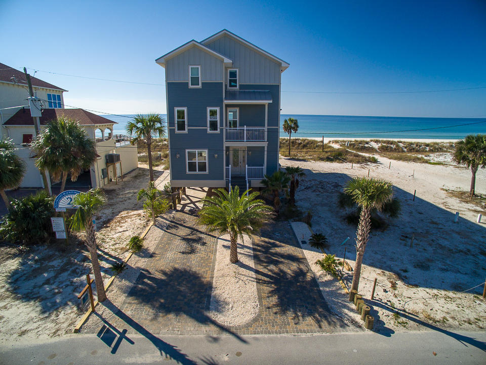 23 feet above sea level, sitting atop crystal white sands, rests a sanctuary, with dramatic East/West gulf views and stylish interior appointments combining to envision one of the most outstanding homes on the Emerald Coast. A one of a kind gulf front showplace located on secluded Beach Blvd offering the best unobstructed views the gulf has to offer from its 3 stories of balconies and wall to wall hurricane impact windows. The entire third floor is dedicated to the incomparable ''Masters Quarters'' featuring an open floor plan, Cathedral ceilings, theater room, kitchen, and a private balcony with a hot tub. The 4 stop luxury elevator allows you to navigate seamlessly throughout the multi leveled home starting from the street level car port underneath the home.