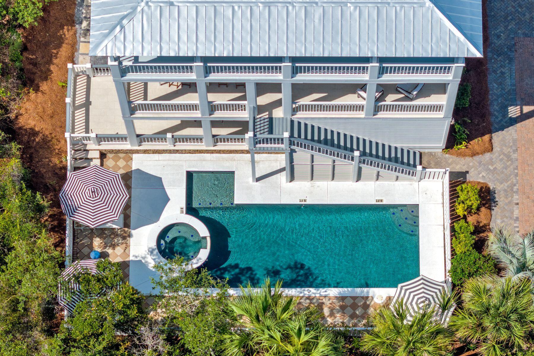 This outstanding gulf-view reunion-sized house only four tiers from the gulf delivers luxury coastal living with an enviable 30A lifestyle. The best part, a private beach with beach service for one small community of homes on the south side of 30A. Located in the upscale, gated community of Sandy Shores, it is one of just 13 luxury homes within this exclusive enclave perfectly tucked away between Rosemary Beach and Alys Beach. Spread over three floors, this newly remodeled home boasts nine bedrooms, nine full baths, two living rooms, two kitchens and multiple porches overlooking a private L-shaped pool and spa. It's a vacation paradise for investors looking for a rental machine, or a luxury retreat for owners looking to spread out and entertain. Deep porches on every level encourag indoor-outdoor living and provide shady nooks for relaxing with a good book or dining alfresco, cooled by gentle sea breezes. Families will love the 40-foot private pool for cooling off and having fun together, along with ping-pong on the patio. Move indoors to play air hockey or watch TV. A brand new full kitchen on this level is the perfect spot for teens and guests to grab snacks and beverages. With 4 x 2 tile flooring throughout the first level, it is perfect for wet feet or sandy toes. You will appreciate two generous bedroom suites on the first floor each with a full bathroom, and one bath accessible from the pool and patio, and laundry. Thoughtfully built with an elevator shaft to all three levels, an elevator could be added for full-time living. Modern coastal decor continues upstairs for a laid-back ambience in the second-floor great room. Lie back in cushioned comfort in the sitting room and appreciate this amazing hideaway. A refectory dining table invites intimate social conversation over tasty local seafood prepared in the coveted chef's kitchen. Fully equipped with high-end appliances, it has everything you need, from the wine refrigerator to the island bar. Three more bedrooms on this level each have a full bathroom. Doors open directly onto a full-width porch with stairs leading down to the pool for a morning dip. The lavish master suite is on the top floor and includes a vast bathroom showcasing a soaking tub with gulf views, large walk-in shower and dual vanities. Throw open the French doors and embrace each new day from the privacy of your own 38-foot balcony. Three additional bedrooms, three beautiful ensuite bathrooms and a second laundry. Last but not least, the metal roof was just replaced in 2025. Contiguous to Paradise by the Sea, this home puts you at the heart of 30A shopping, upscale and casual dining, and non-stop entertainment. The white-sand beach offers private access for owners and a seasonal beach chair service. Consistently generating more than $350,000 in rental income, this outstanding beach house with parking for eight vehicles is an entertainer's nirvana and the perfect venue for weddings, reunions and family gatherings.