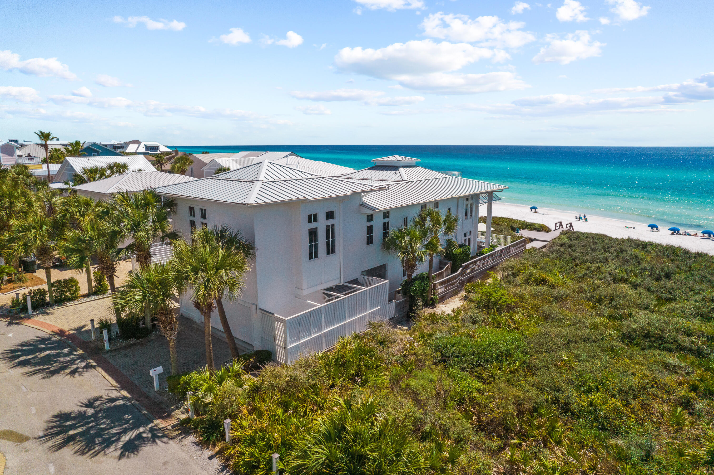 Located on the gulf in the gated community of Majestic Beach, this idyllic beach home sits atop an elevated dune with panoramic views of the emerald green waters of the gulf coast. A private courtyard leads to the entrance of this 5 bedroom home, with 5 full baths and 2 half baths. Views to the gulf are immediately reveled as you step inside this coastal retreat. The living, dining and kitchen areas are filled with natural light from windows reaching ceiling to floor facing the gulf. French doors lead to a porch for outside dining and to your private beach access to the sugar white sandy beach. The chef's kitchen features coffered ceilings, expansive island seating for eight, walk-in pantry, dual Wolf ovens and warming draws, Thermador gas cooktop, Subzero refrigerator with separate