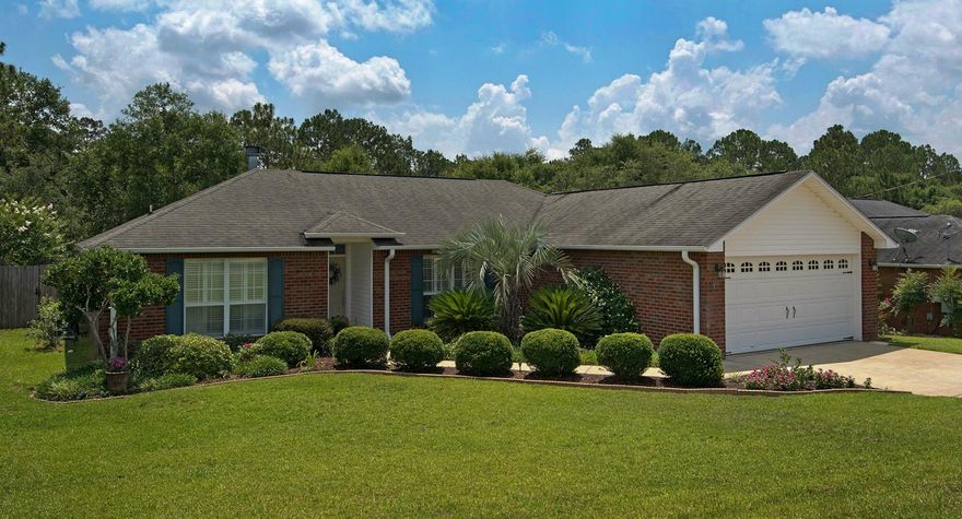 You're going to love this home! This extremely well-maintained property will impress you both inside and out. The curb appeal is prominent, fully sodded with appealing landscaping, all kept beautiful by the whole yard sprinkler system and the home's gutters and French drain system. The interior of the home features teak hardwood flooring throughout the main areas, plantation shutters in the main areas and front bedroom, and French doors to the backyard. Living room features wood-burning fireplace. The kitchen has a built-in banquet with TONS of seating, and plenty of room for a large table- plus additional seating available at breakfast bar. Stainless steel appliance set is only 3 years old and features double oven and French door refrigerator. Tile backsplash adds to the aesthetic