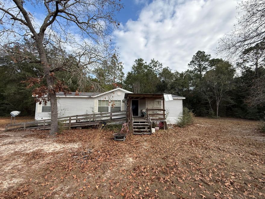 DISCOVER peaceful North West FL living with room to breathe on 1 Acre! Nestled in a quiet, rural setting, this property offers the perfect blend of privacy, convenience, and Florida charm. Whether you're looking for a primary residence, a homestead-style lifestyle, or space to spread out, this home delivers a relaxed pace and access to nearby amenities.Enjoy Blackwater River State Forest, Hurricane Lake, and local parks just a short drive awaya'perfect for hiking, kayaking, fishing, and weekend adventures. You'll also appreciate the convenient proximity to Pensacola, Navarre Beach, Whiting Field, NAS and Hurlburt AFB. The Home is for sale AS IS.  The Buyer must verify and satisfy themselves as to all facts deemed material, including but not limited to property condition, zoning, land use, measurements, room sizes, utilities, schools, restrictions, and any known or unknown conditions. Outbuildings do not convey.