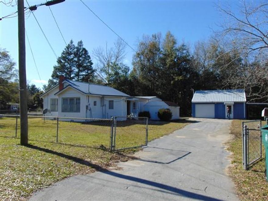 This FL cottage is located on a 3/4 acre fenced lot in town. Cottage is 2 BR, 1 bath with a spacious kitchen and lots of cabinet space. Home has central H&A. There is a detached shop/garage with a portion of shop converted to guest quarters with living/bedroom area and a full bath. Entire lot is chain link fenced; detached carport; storage shed. 2015 taxes paid just $436.53 without homestead. Schedule your showing today!