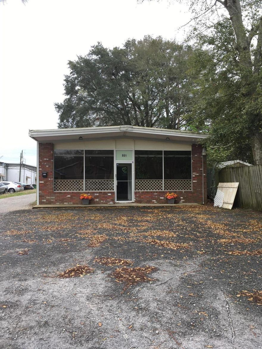 Freestanding building with bathroom, office and large open area.