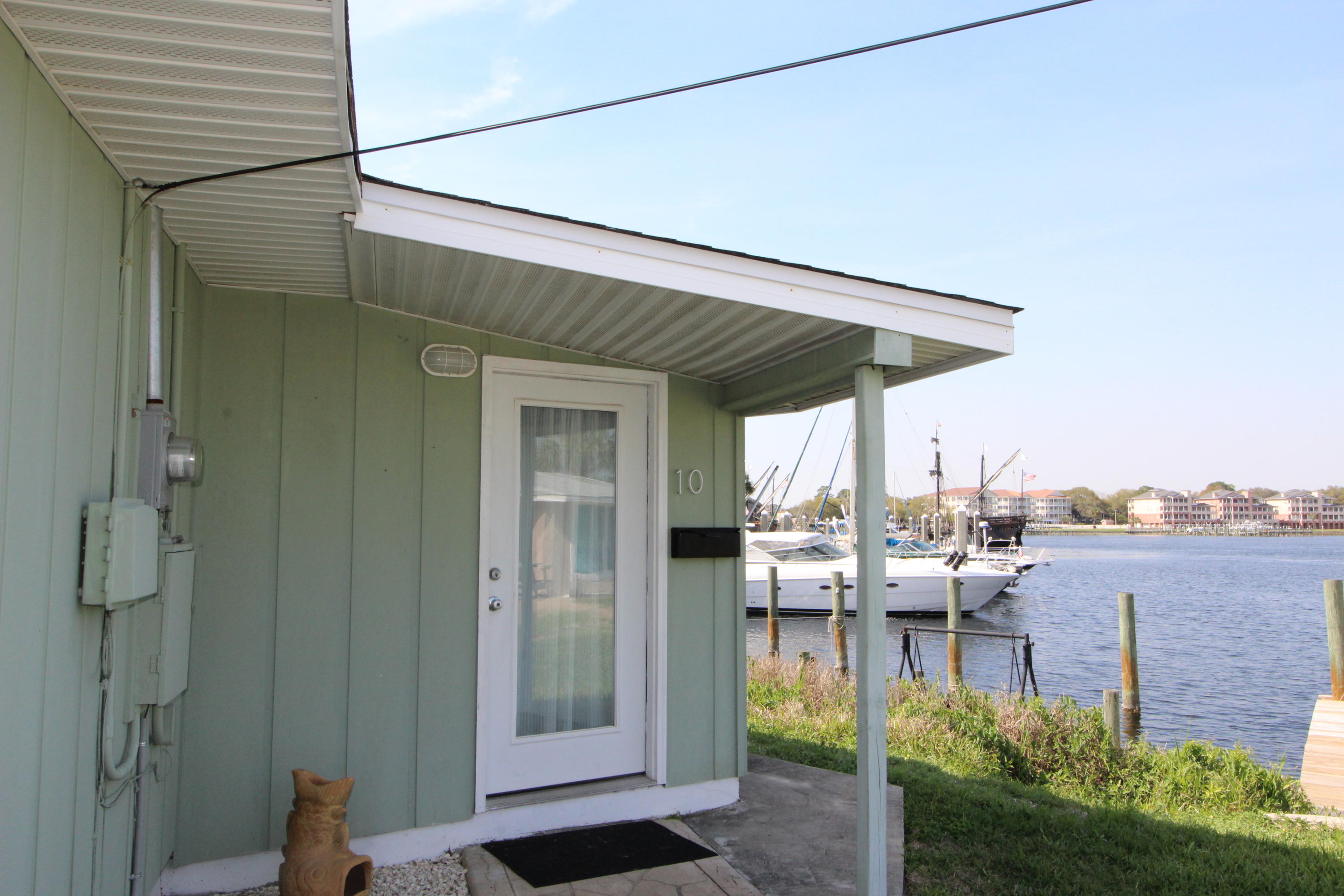 ENJOY WATER VIEWS AND BOAT SLIP IN THIS UNIQUE WATERFRONT COMMUNITY! Step into this octagon shaped cottage with a gorgeous view and access to the Santa Rosa Sound. The living room opens into the Florida room with several sliding glass doors leading out to the patio, the Sound, and the community dock. Cathedral ceilings, tile throughout the main living areas, and remodeled bathrooms. Well maintained complex with pool and picnic area.