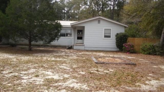 3 Bedroom, 1 Bath located in Defuniak Springs, FL. This property has hardwood and tiled floors throughout. Ceiling fans are a nice touch. The kitchen and bathroom will need updates. Back yard is wooded and has storage shed. 1 carport on side of home. Fresh paint is needed throughout home. Other repairs and updates may be necessary before move in ready. Great potential!