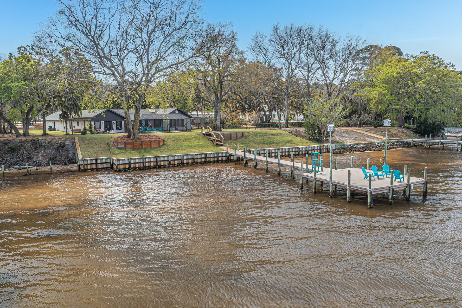 Perfectly situated, high and dry, in the heart of Destin on Prestigious Indian Trail, easily one of Destin's most sought after locations, sits this elegant, secluded, one level, 4 Bedroom, 3.5 Bath, 3036 square foot bay front estate home with two master suites, a screened and heated saltwater gunite pool, an oversized 3 car garage on a very private 1.2 acre lot including 100 feet of waterfront directly on Choctawhatchee Bay. This fabulous lot includes mature shade trees, manicured, irrigated, freshly sodded lawn as well as open natural spaces, there are even honeybees making honey on the property. Brick pavers form the driveway leading from the road to the house and also from the pool area down to the new dock with ThruFlow decking material to help limit dock damage from future storms.