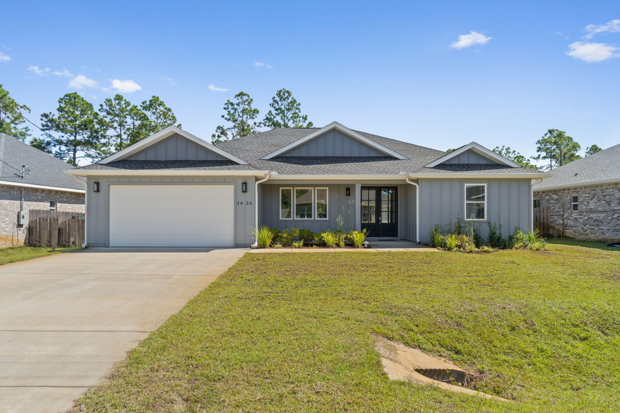 Discover the convenience and comfort of this beautiful 4-bedroom, 2-bathroom home featuring 2,164 square feet of thoughtfully designed space. The open concept living area seamlessly blends with a modern kitchen equipped with stainless steel appliances, quartz countertops, and soft-close shaker cabinets. Enjoy durable luxury vinyl plank flooring throughout the home. The master suite highlights a tray ceiling, walk-in custom closet, and a fully tiled master bath shower. An oversized back porch and a garage with gutters and epoxy flooring add practical advantages. A washer and dryer are also included, ensuring this home is ready for move-in.