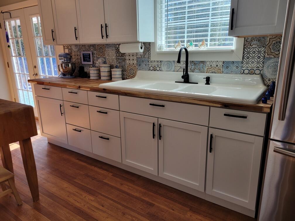 Radiant Ranch on Sandy Creek! Serenely located on a spacious 1.34 + acre lot in a country setting, this 3 bedroom/2 bathroom, warmly welcomes with a brick exterior, neat landscaping, a covered entryway, and a beautiful backdrop of mature trees. Step inside this luminous and immaculately maintained interior find tons of natural light, gorgeous LPV flooring, an openly flowing traditional floorpan, and an expansive living room with a marvelously detailed and extra-wide door casing. For elegant holiday parties, the formal dining room delivers with stunning faux stone accent wallpaper, & bright white trim.Designed to accommodate both cooking and casual entertaining, the stylishly updated kitchen features a dual bowl farmhouse sink and butcher block countertops!Call today for your private tour!