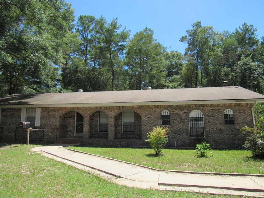 Don't miss the opportunity to own this beautiful brick rancher! Located in the Portland Community, West of Freeport, this home is situated on 2.4 acres and is convenient to DeFuniak, Niceville and the Beaches of South Walton! This 3/2 home features a large living room AND family room (with fireplace). The galley kitchen features a stainless refrigerator that conveys. There is a large Florida room overlooking the wooded backyard. This property has been beautifully landscaped and is there is plenty of room to grow a garden. There are paved sidewalks leading to a covered porch to welcome your guests. The side garage features plenty of room for your tools and car! Don't miss out, Call for your tour today