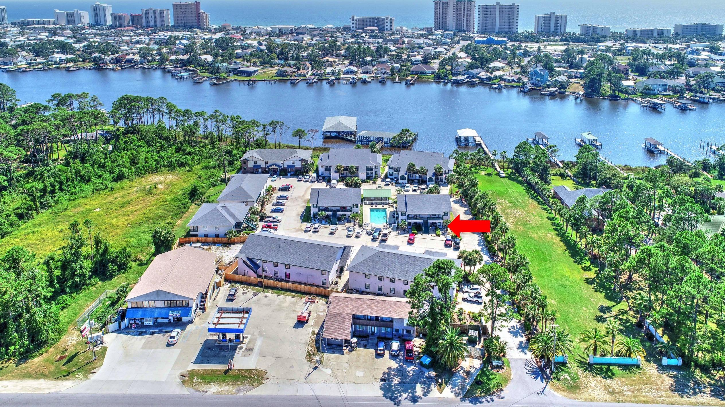 Fantastic ground floor unit in Greenwood Estates and it comes with a deeded boat slip! This 2BR/2BA condo has been updated in recent years and offers a view of Grand Lagoon from the enclosed sun porch. Upgrades include tile and luxury plank vinyl flooring, granite countertops, custom tiled backsplash in the kitchen and both baths have designer tile accents, and unlike most units in the Greenwood Estates complex, this unit has a second entrance! Building 6 is right next to the pool and you're just steps from the boat dock. Speaking of the dock, the deeded slip does have a lift for a pontoon/patio boat. Low density, easy maintenance, on the water and convenient to everything! What else do you need? All info is approx and must be verified by Buyers if important.