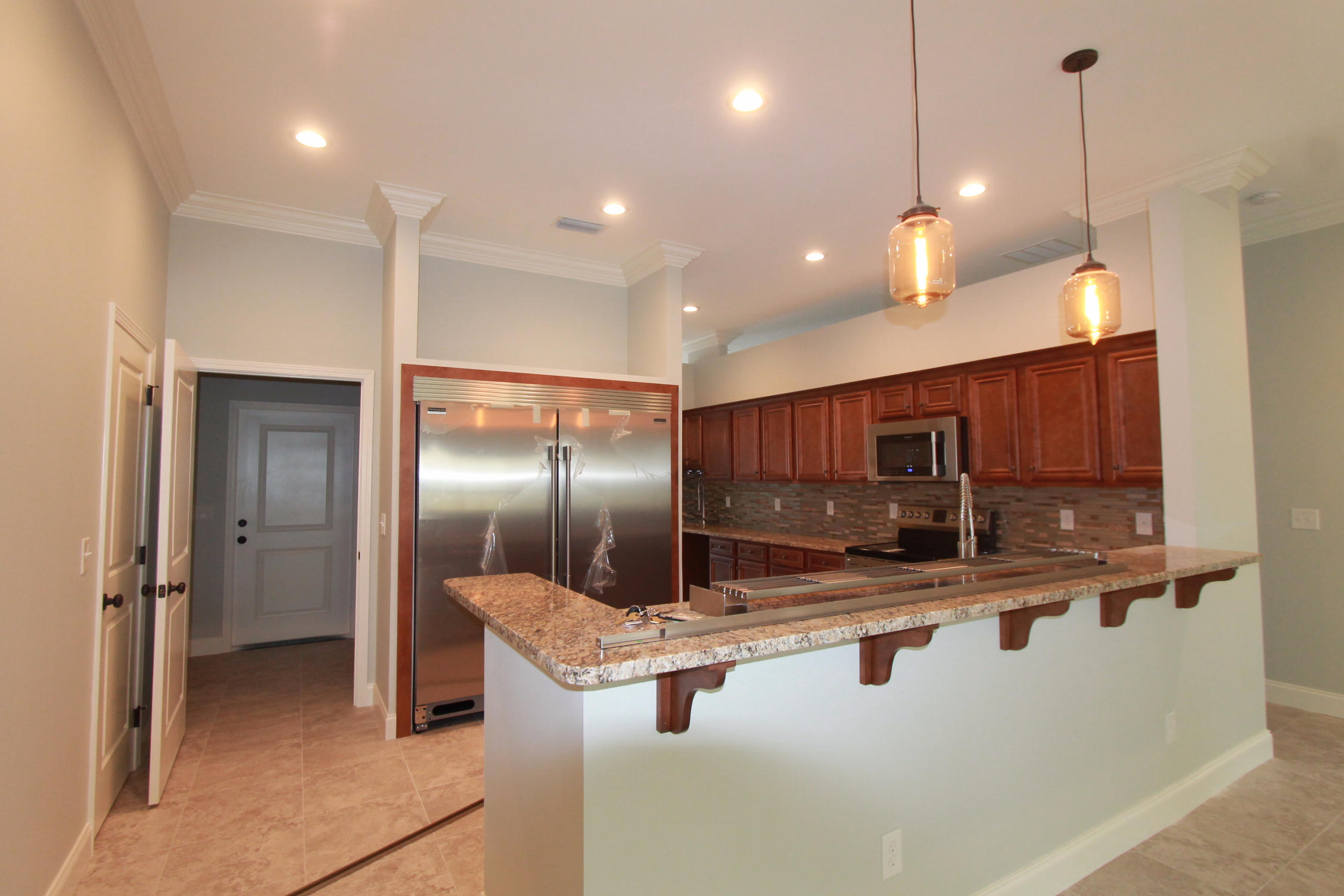 Completed and ready for you!! Just 1.8 miles from Hurlburt AFB front gate! This 4/3 custom brick home has super curb appeal, and is being constructed on large lot. There are 10 Ft. ceilings w/ impressive crown molding, tile flooring throughout the main living and wet areas, and 5 1/4'' baseboard throughout. As you enter the home, through the covered front porch, the formal dining room is on your left. As you continue down the hallway, you will then enter the chef's delight kitchen which boasts custom maple cabinetry, granite countertops, 2 large pantry's, and stainless appliances (including an oversized commercial grade frig./freezer). The oversized greatroom is located at the rear of the home and opens to a covered porch, which is perfect for entertaining. The master suite has 2 large walk - in closets, a linen closet, a walk - in tiled shower with custom glass shower door, a whirlpool garden tub, and a double vanity. Baths 2 and 3 are located at the left of the home, along with the 3 additional bedrooms. The laundry room is at the right of the kitchen, and has a door which opens to the garage. The fully fenced yard will be beautifully landscaped, and comes complete w/ a well, sprinkler system and timer. Insurance will be very reasonable, as home is built to today's code, and window coverings are being provided for storm protection. Home was completed in late May. Seller is offering to pay $4500 of buyers closing costs, and title insurance.