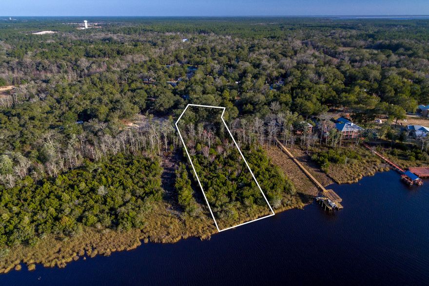 This 1.33 acre lot offers 100 feet of water frontage on Alaqua Bayou inside Waterview Cove Subdivision. What a beautiful location for a new home!...A Nature Lovers Dream with old Oaks and breathtaking views, offering the best of waterfront living and the convenience of Destin Shopping and Gulf Beaches. NO ASSOCIATION DUES, AND NO BUILT OUT! PARADISE!