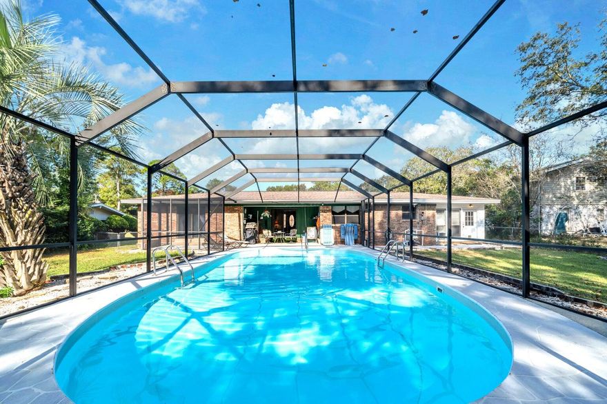 Large Screened in POOL!  Your entrance into your home is a brick courtyard with a double rod iron gate.  As you open your double doors to enter you see your screened in-ground pool and lanai.  As you walk in straight ahead is your living area with sliding glass doors to your pool.  Leave those open-your pool is screened.  To the left of your living area is your formal dining room.  That opens up to your kitchen.  If you enter your home and take a left, instead of going to the living, you go into your family room that has a fireplace and Pergo floors it is open to the dining and kitchen.  The kitchen has tons of newer cabinet and counter tops.  French doors separate the family room from the Florida room.