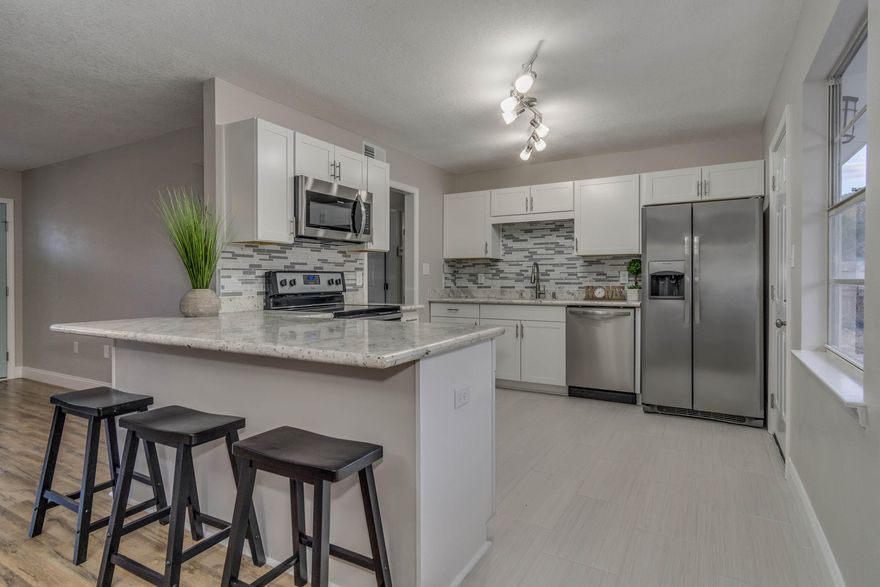 Beautifully remodeled 5 bedroom 2 bath Home in Fort Walton Beach. You will love entertaining with the open floor plan. The kitchen has Brand New white Shaker cabinets, gorgeous granite countertops, backsplash and Stainless Steel Appliances. NEW copper wiring throughout, NEW WINDOWS and sliding glass door scheduled for install, NEW flooring, doors, baseboards, vanities, fixtures and insulation. Enjoy entertaining in the large fenced in back yard, pet friendly and perfect for cookouts and family gatherings. Don't let the sqft fool you. This Home has a LOT of room. The 5th Bedroom could be a family room. There is a one car garage. Great quiet neighborhood with lots of privacy. Close to 98, military bases, schools, shopping and other amenities. Don't wait, come tour this home today!