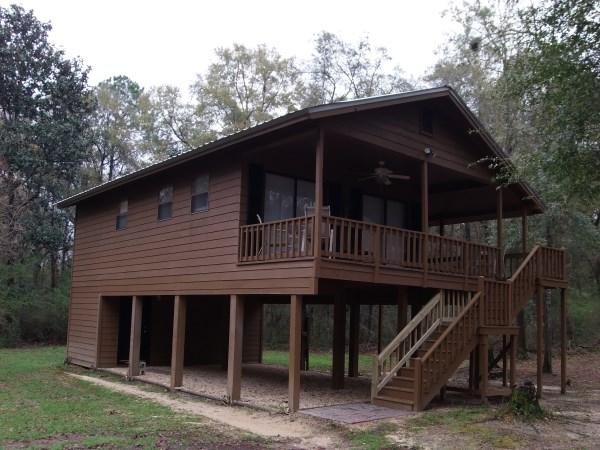 This is an immaculate fully furnished cabin on 2.2 acres. You will be surprised at how well the space was utilized in this 2 BR cabin with central heat and air. Sliding glass doors open onto the wrap-around porches to provide spectacular views. Seller has existing survey. Schedule your showing today!