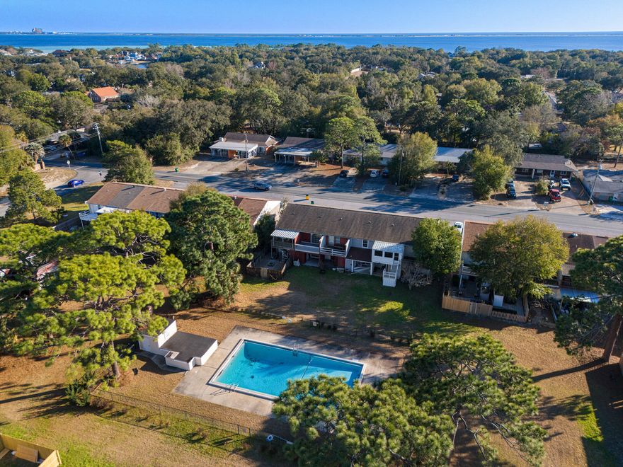 This well-designed 2-bed, 2-bath townhome offers a functional layout with great use of space and privacy. The main level features a spacious living area and dedicated dining space overlooking the back patio and community pool. The kitchen includes ample cabinet storage and stainless steel appliances, while the laundry room is conveniently located just off the patio with additional storage.Upstairs, both bedrooms are generously sized. One bedroom opens to an oversized balcony with a direct view of the pool. A second full bath and a large storage area are located between the bedrooms, creating a smart and practical layout with plenty of closet space for all. Ideally situated just 7 minutes to Eglin AFB and 22 minutes to Hurlburt Field, with a public boat launch and Meigs Park less than a mile away.