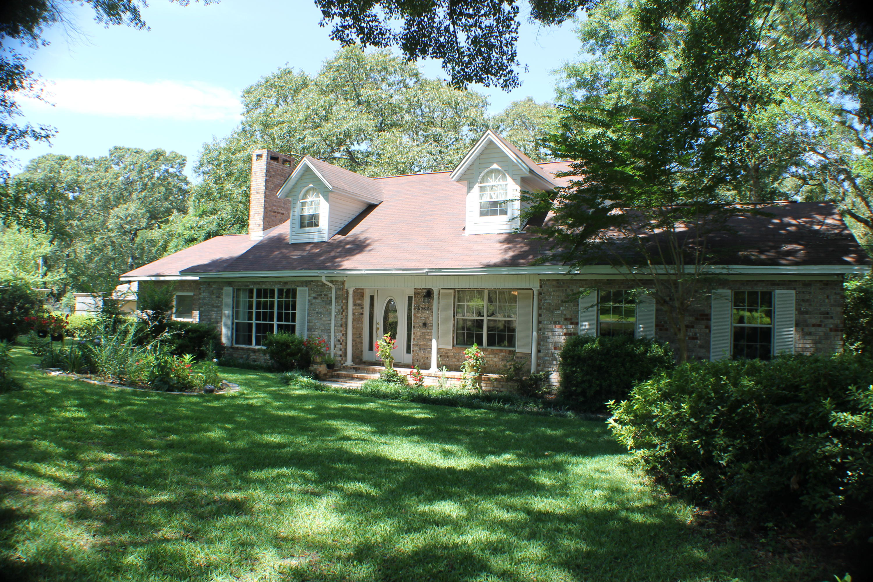 A must see country style home! Featuring two stories. Down stairs has the two master bedrooms,one having access to it's own deck,walk in shower,jacuzzie, and ciltured marlble vanities. Living room features a beautiful marble stone start gas/wood burning fire place. Living Room has large windows that you can look out front and watch the birds or even out back. Kitchen has new counter tops and stainless steel appliances. Also custom solid oak wood cabinets. Up stairs, there are two more rooms and another bathroom. House is located close to all the major necessities, Crestview High School, Post Office, Library, Winn-Dixie, and the Movie Theater. Also out back is a nice open yard and a porch and beautiful trees for shade. Are you into gardening? The landscaping flourishes with tons of color