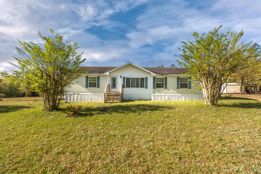 Over 11 acres of peace! This country home is 3 bedrooms, 2 full bath with 2 living room areas and office space. Laminate flooring in the main areas. One owner home. Master suite is large and bath has separate shower, large soaking tub, and double vanities. Back patio overlooks the 11 acre home site. Mature trees line the drive and back of property. This one is truly private, yet only 4 miles from the interstate. (South of I-10). Owner is leaving the whole house Generator & its propane tank, a large yard building for extra storage, and safe in back bedroom for your valuables. Hot-tub does not convey.