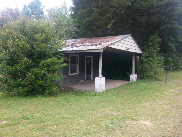 triangular shaped lot with over 100 foot hwy 90 frontage. NO value given to the house.