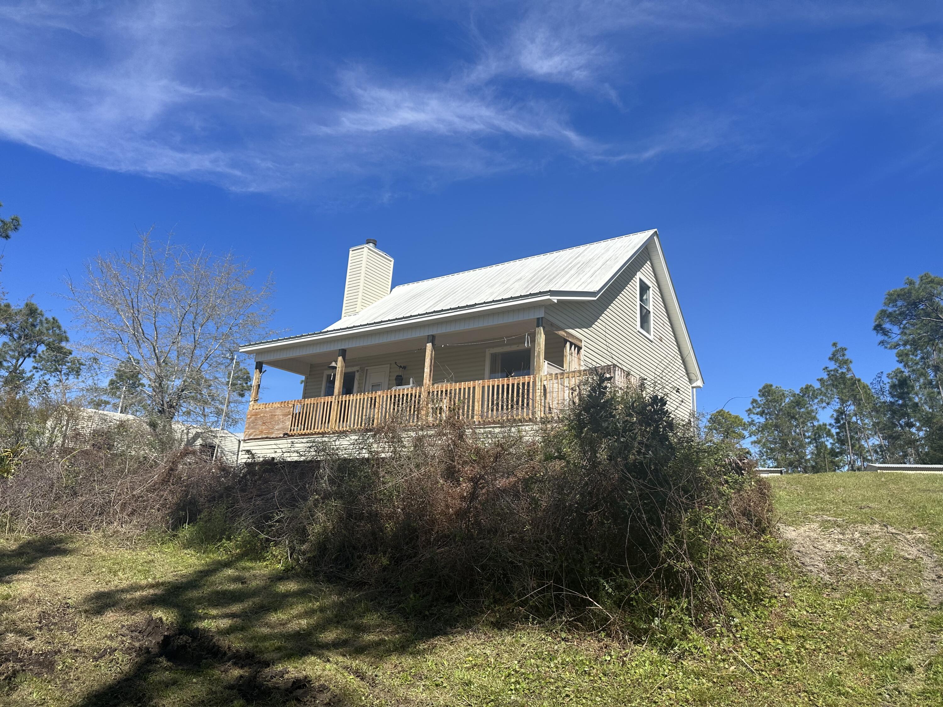 218' WATERFRONT HOME - 1.7 acres - Open Floor Plan Concept, High Ceilings, Fireplace, Balcony, 1 BR, plus large LOFT as a 2nd BR, w/storage closets. (Loft adds additional sq ft). ENJOY BEAUTIFUL Sunrises, Sunsets, & Water Views! BONUS, only 10 miles to the beautiful, sugar-sandy beaches of Mexico Beach! A little East is Port St. Joe, a little West is Tyndall AFB. You, family, friends, & pets can relax & enjoy the great outdoor space this property offers. NO HOA. Home Sweet Home with endless possibilities, Fishing Cabin, 2nd FL Home, Vacation Rentals, OPPORTUNITY KNOCKS, potential to subdivide 1 unit per 1/2 ac . Water Access to INTER-COASTAL WATERWAY, & GULF OF AMERICA, Port St. Joe, & St. Andrew's Bay. DEEP WATER BOAT DRAFT 5'. TOURS AVAILABLE, Call or Text Today! Buyers to verify any information pertinent to Buyer. Call Today To Schedule Your Showing!
