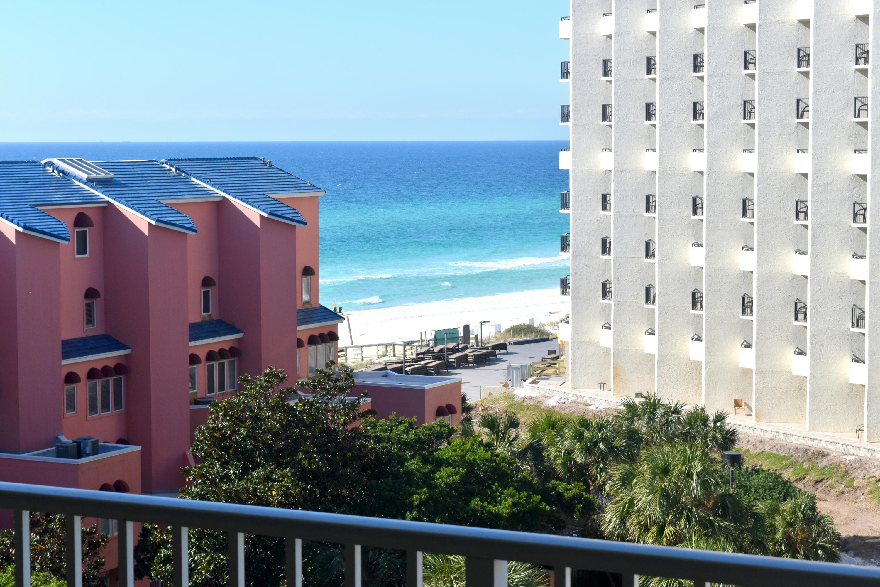 COOL COASTAL STAGING transports you to your Happy Place. Nice views of the gulf from this two bedroom, two bath freshly painted & updated condo. Kitchen features pretty granite countertops, new sink & hardware, & white cabinets. Both baths also sport granite counter tops. The living/dining area is quite spacious & opens to a wrap balcony with plenty of space. There is updated tile in all living areas with almost new carpet in the bedrooms. The master bedroom suite has a luxury bath with whirlpool tub, separate shower, & double vanities. The master bedroom houses a king bed while the second bedroom has double bunks. Other amenities include a stackable washer/dryer & custom draperies. Tops'l offers over fifty acres of lush landscaping with almost 600 feet of private beach. It