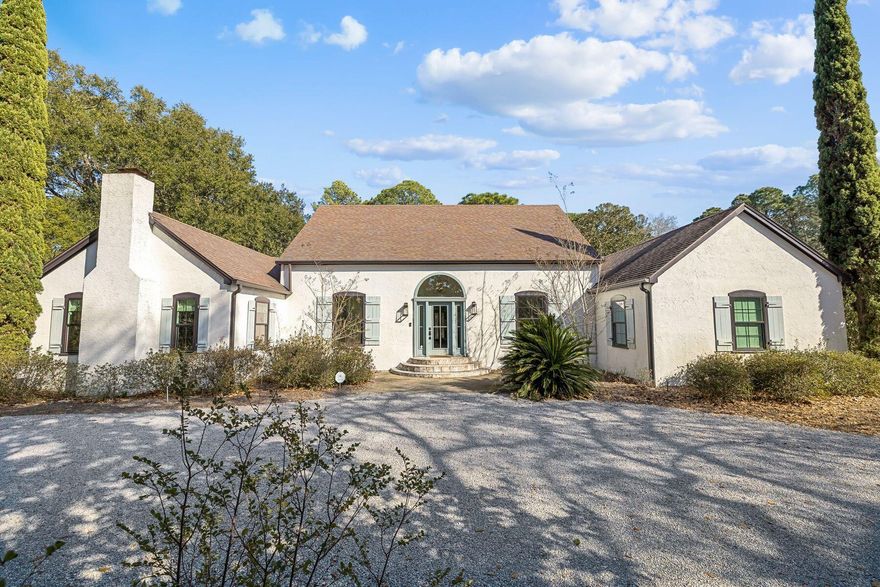 An extraordinary waterfront sanctuary awaits at this fully renovated canal-front residence, privately positioned on an estate-sized one-acre homesite in the heart of Santa Rosa Beach. Offering increasingly rare acreage just minutes from Scenic 30A, this property delivers a compelling blend of space, privacy, and waterfront access. Framed by towering magnolias, grand live oaks, and lush indigenous landscaping, the setting feels secluded and serene while remaining close to the sugar-white beaches, dining, and lifestyle amenities that define the area. A private canal dock provides direct water access.The 3,070-square-foot interior was meticulously renovated in 2022, blending timeless character with modern refinement. An expansive 600-square-foot enclosed lanai spans the width of the home, thoughtfully oriented to capture peaceful backyard views and extend living spaces year-round.

The expansive grounds provide exceptional flexibility, with ample room for a future pool, guest house, carriage house, or additional garage--offering the opportunity to create a true estate compound tailored to your vision. A heated and cooled flex space (not included in the square footage) located behind the garage adds further versatility, ideal as a private office, fitness studio, creative retreat, workshop, or conditioned storage.

Remarkable privacy and natural beauty are paired with unmatched convenience, just moments from Grand Boulevard's boutique shopping and dining, Sacred Heart Medical Center, and the best of Scenic 30A.

A truly exceptional offering--combining estate-sized acreage, waterfront access, and modern renovation in one of Santa Rosa Beach's most desirable settings.